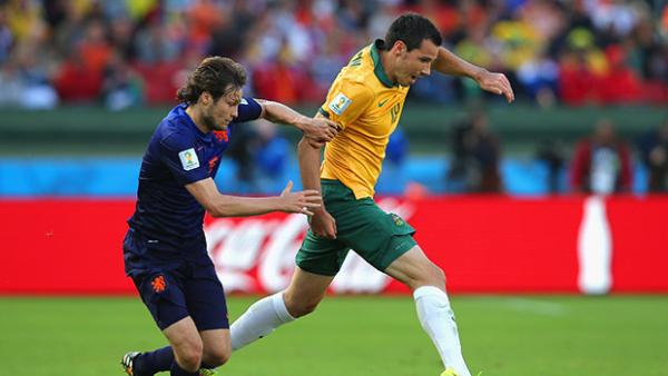 McGowan challenges for the ball with Daley Blind of the Netherlands.