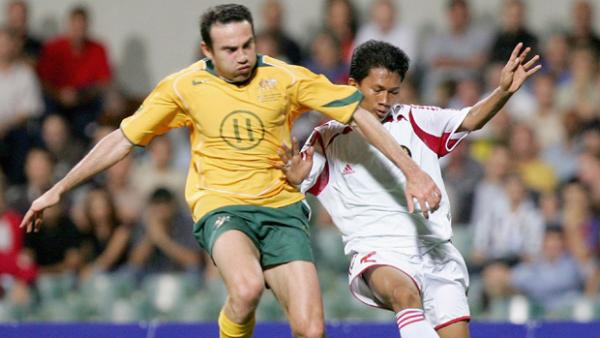 Stan Lazaridis of Australia contests the ball with Ismed Sofyan of Indonesia.