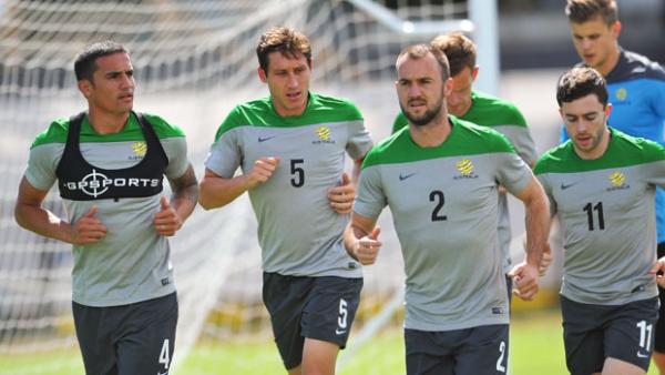 Socceroos players warm-up during a training session in Melbourne.