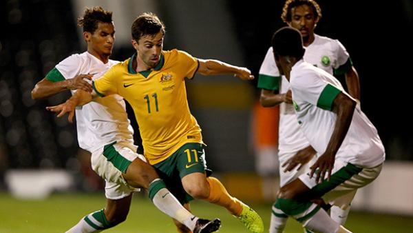 Socceroo Tommy Oar tries to weave past Saudi Arabia's defence.