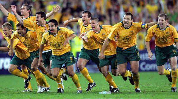 Socceroos players celebrate amid chaotic scenes in Sydney.