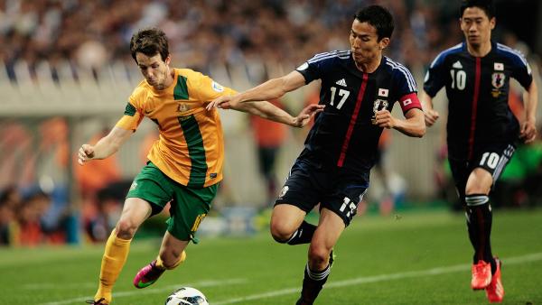 Robbie Kruse takes on a Japanese defender when the Caltex Socceroos played Japan in Saitama in 2013.