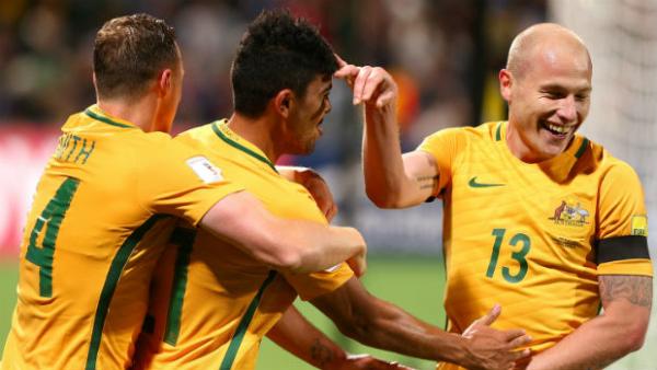 Caltex Socceroos Brad Smith, Mass Luongo and Aaron Mooy celebrate a goal in World Cup qualifying.