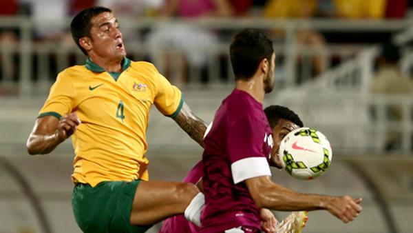 Tim Cahill fights for the ball against Qatar.