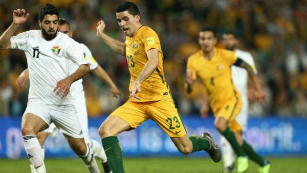 Tom Rogic unleashes a shot against Jordan at Allianz Stadium.
