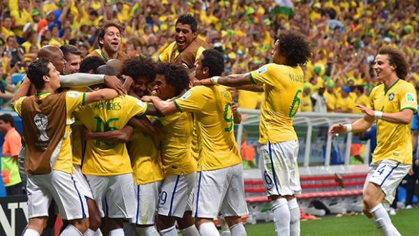 The Brazil squad celebrate after scoring a fourth goal against Cameroon.