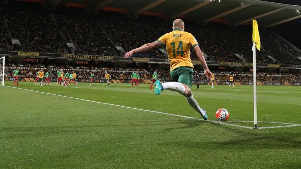Aaron Mooy whips in a ball against Bangladesh.