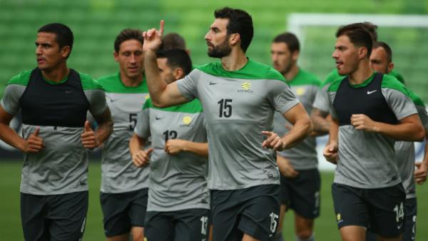 Socceroos captain Mile Jedinak leads the team during training in Melbourne.