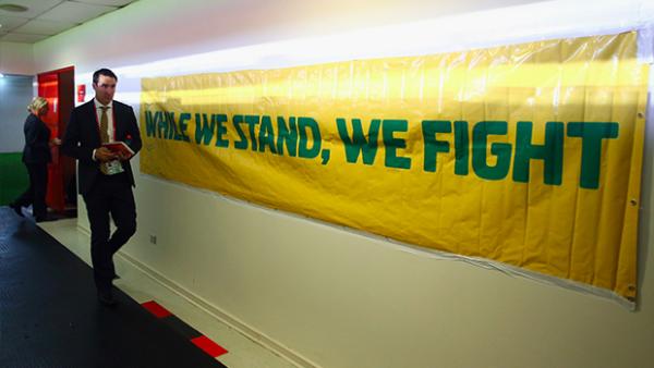 Joeys head coach Tony Vidmar walks down the tunnel with an Australian banner on display