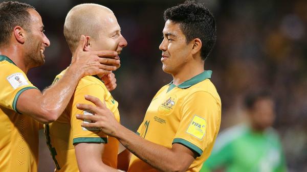 Aaron Mooy celebrates a goal with teammates Tarek Elrich and Massimo Luongo.