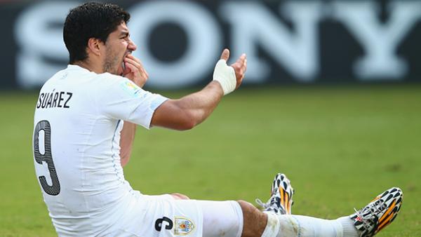 Suarez reacts after the alleged biting incident against Italy.