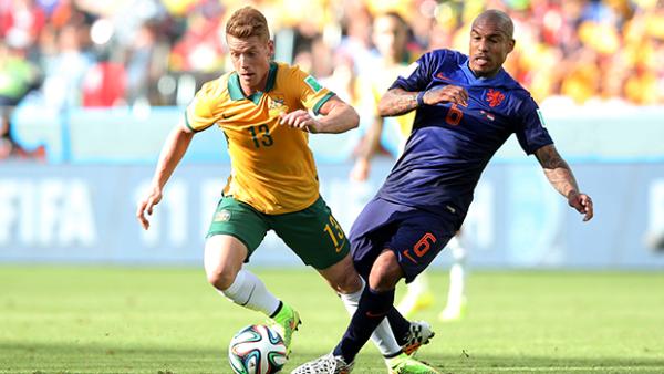 Socceroo Oliver Bozanic pressures Netherland's Nigel de Jong during his World Cup debut.