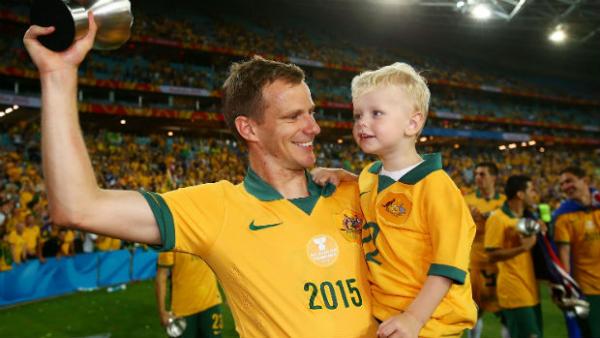 Defender Alex Wilkinson celebrates the Socceroos' Asian Cup triumph.