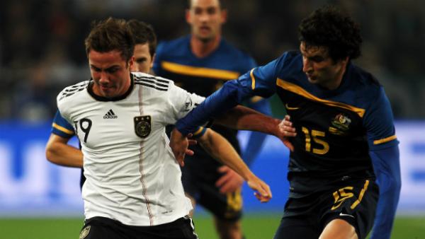 Germany's World Cup hero Mario Goetze jostles with Socceroos skipper Mile Jedinak when the side's played in 2011.