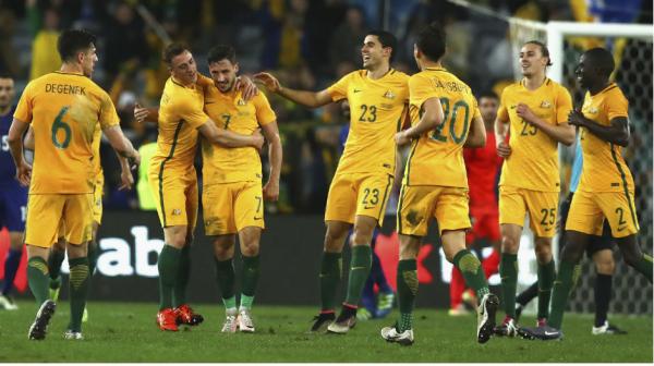 The Caltex Socceroos celebrate Mathew Leckie's late winner at ANZ Stadium.