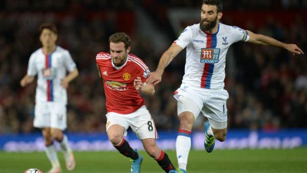 Mile Jedinak fights for the ball with Manchester United's Juan Mata.