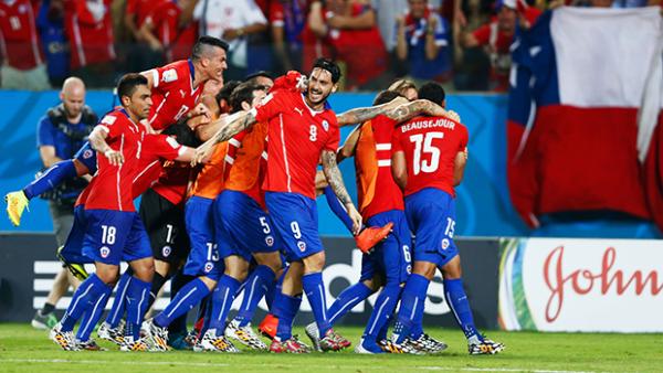 Chile celebrate after beating Australia in their opening World Cup match in Brazil.