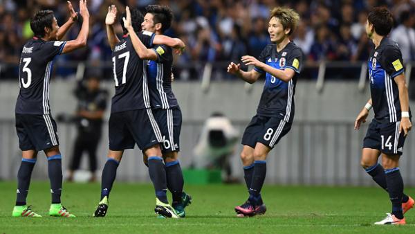 Japan players celebrate a goal in their 2-1 win over Iraq.