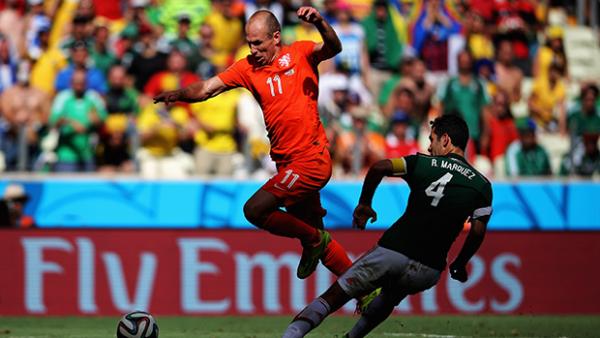 Dutch attacker Arjen Robben skips a tackle from Mexico's Rafael Marquez.