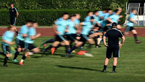 The Caltex Socceroos on the training ground under the watchful eye of Ange Postecoglou.