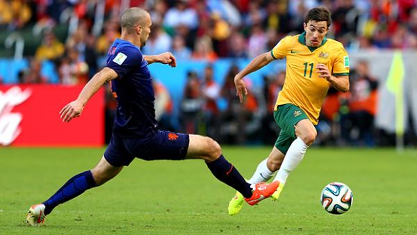 Tommy Oar dribbles past Holland defender Ron Vlaar.
