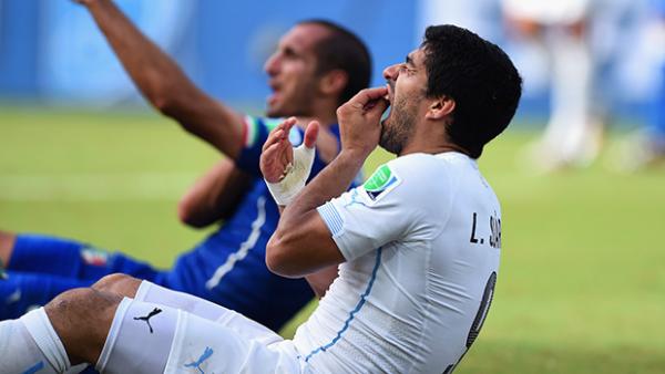Uruguay striker Luis Suarez's reaction after biting Italy's Giorgio Chiellini.
