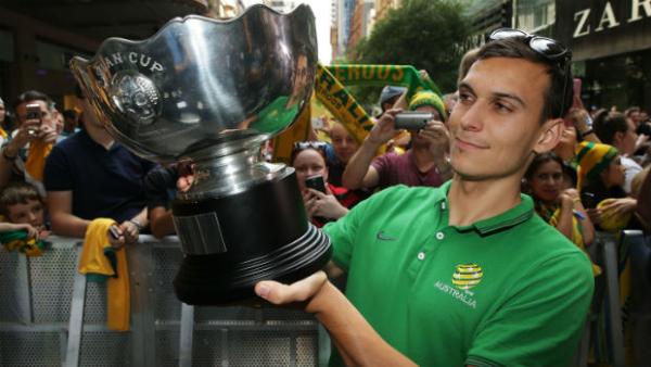Socceroos defender Trent Sainsbury lifts the Asian Cup.