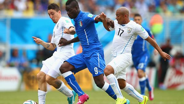 Balotelli challenges for the ball during Italy's 1-0 loss to Uruguay.