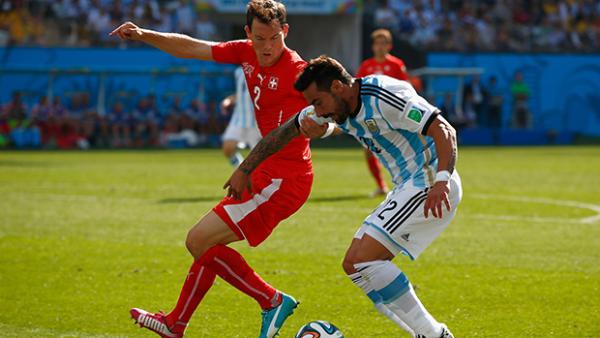 Lichtsteiner challenges Ezequiel Lavezzi during Switzerland's loss to Argentina.