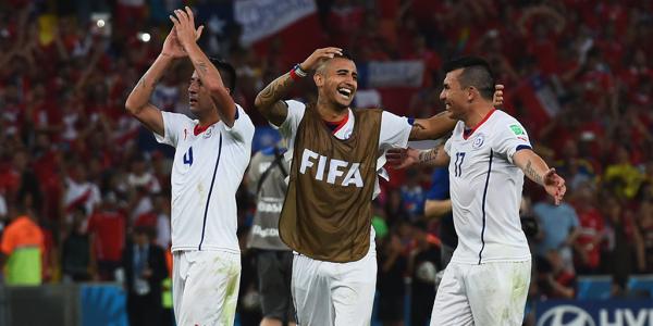 Chilean players celebrate their win over Spain which sees them through to the Round of 16.
