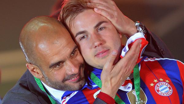 Bayern Munich's Pep Guardiola and Mario Goetze celebrate after winning the DFB Cup Final.