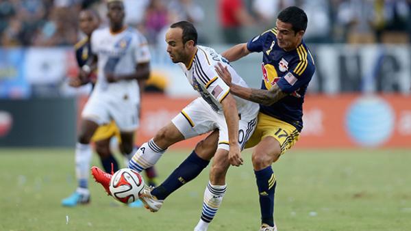 Tim Cahill makes a challenge on LA Galaxy's Landon Donovan.