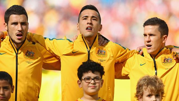 Jason Davidson sings the national anthem alongside Matt Leckie and Matt McKay before the Socceroos match against the Dutch.