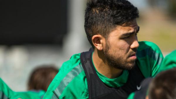 Massimo Luongo stretches at Socceroos training on Monday.