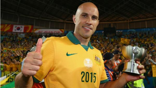 Socceroos midfielder Mark Bresciano celebrates with his Asian Cup winners trophy.