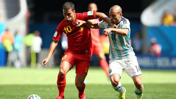 Belgium's Eden Hazard fends off attention from Argentina's Javier Mascherano.