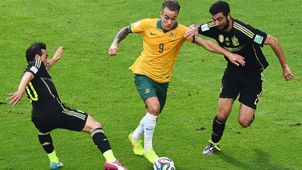 Taggart is challenged by Santi Cazorla and Raul Albiol during Australia's 3-0 loss to Spain.