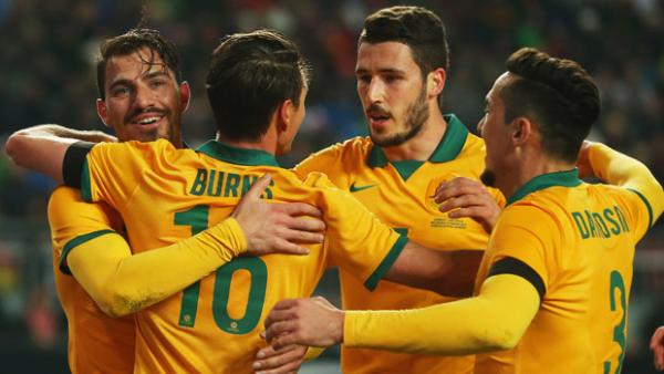 Socceroos players celebrate a goal in their 2-2 draw with Germany in March.