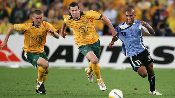 Brett Emerton fights for the ball with Uruguay's Mario Regueiro in 2005.