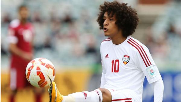 UAE's Omar Abdulrahman juggles the ball against Qatar.