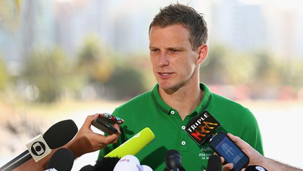 Alex Wilkinson addresses the media outside the Socceroos base in Vitoria.