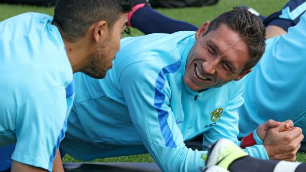 Mark Milligan on the training ground alongside Massimo Luongo.