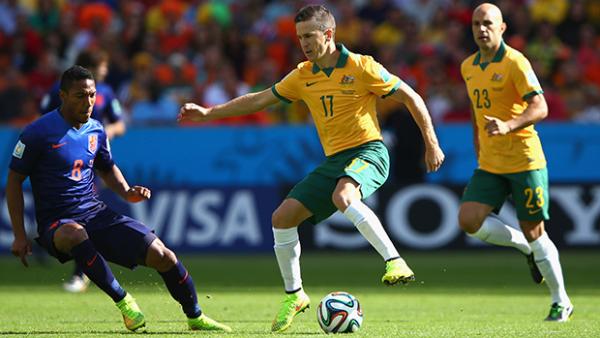McKay takes on Jonathan de Guzman in Australia's clash with the Netherlands.