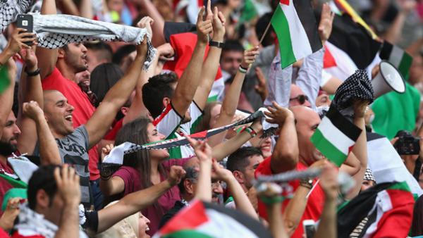 Palestinian fans show their support during their nation's clash with Jordan.