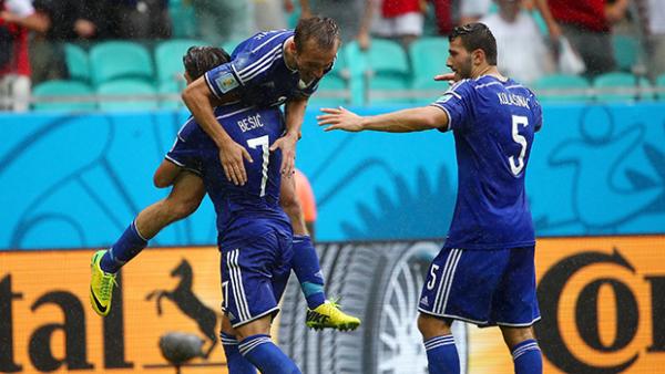 Bosnia celebrate after scoring their third goal against Iran.
