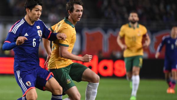 Socceroo Robbie Kruse fights for the ball with Japan's Masato Morishige in a 2014 friendly.
