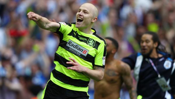 Aaron Mooy has sealed a permanent move to Huddersfield Town.