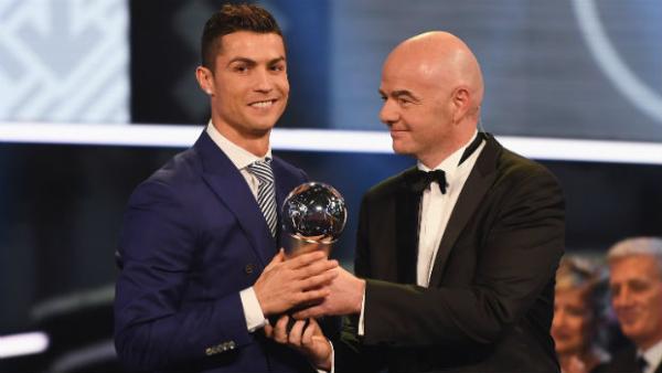 Cristiano Ronaldo accepts his World Player of the Year award from FIFA President Gianni Infantino.