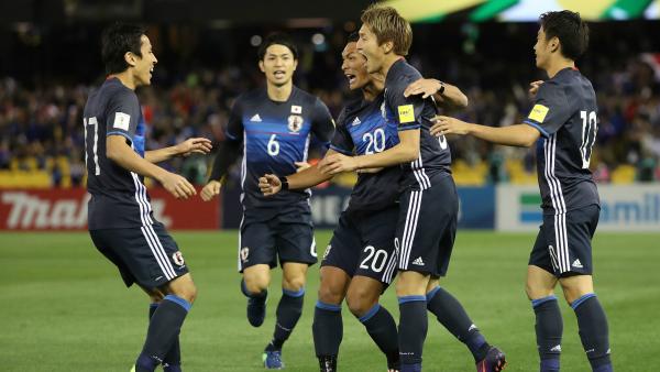 Japanese players celebrate a goal in their 1-1 draw with the Caltex Socceroos in October, 2016.