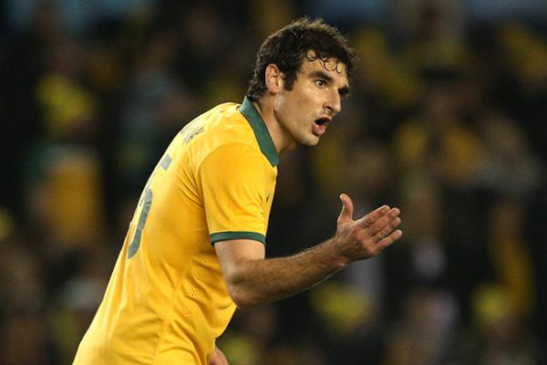 Mile Jedinak directing traffic in his first match as skipper against Ecuador earlier this year.